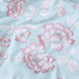 Azure Bloom Comforter | Luxurious Satin Comforter with Golden Floral Embroidery Focus view.
