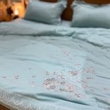 Azure Bloom Comforter | Luxurious Satin Comforter with Golden Floral Embroidery Overall view.