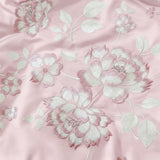Blush Petal Comforter | Satin Embroidered Floral Comforter in Soft Blush Cream Focus view. 