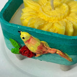 Handcrafted Bird & Flower Cement Candle | Turquoise Teal Holder with Yellow Bloom Candle Closeup view