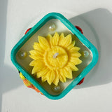 Handcrafted Bird & Flower Cement Candle | Turquoise Teal Holder with Yellow Bloom Candle Top view