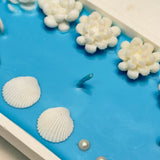 Handmade Ocean-Inspired Oval Candle with Seashells & White Floral Carvings | Luxury Centerpiece Closeup vew