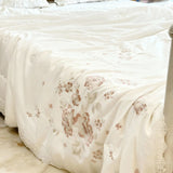 Ivory Blossom Comforter | Luxurious Embroidered Floral Comforter with Satin Finish focus view.