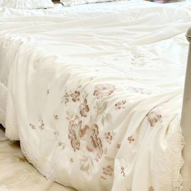 Ivory Blossom Comforter | Luxurious Embroidered Floral Comforter with Satin Finish focus view.
